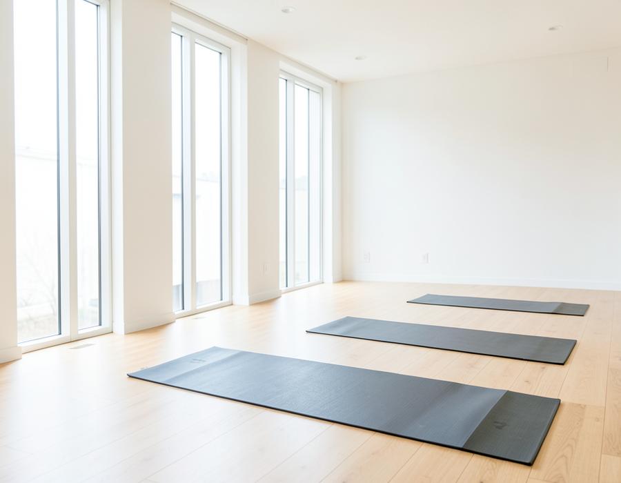 Sunlit yoga studio with mats laid out